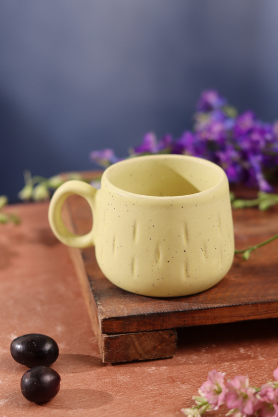 Mellow yellow chai cup on wooden surface