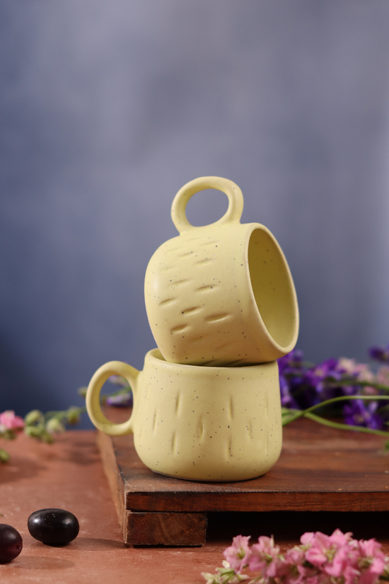 Mellow yellow tea cup on wooden surface