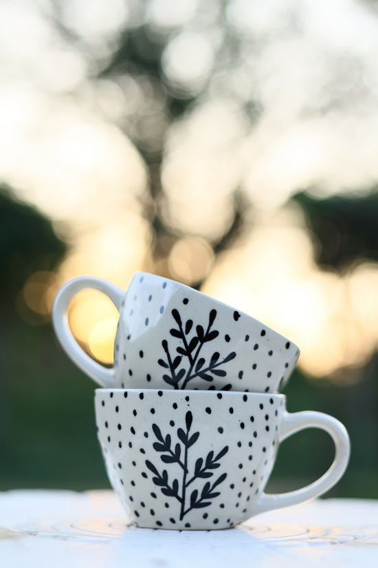Black leaf coffee mug on other