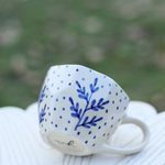 Blue fall leaf coffee mug on surface