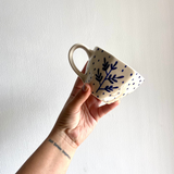 Blue fall leaf coffee mug in hand