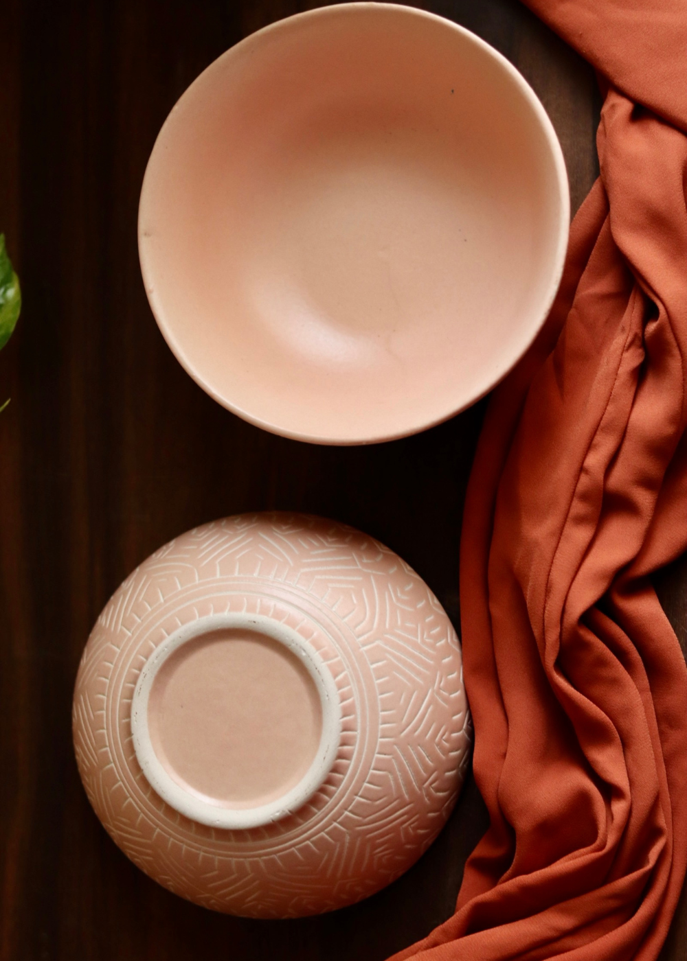 Blush pink carved curry bowl with red cloth