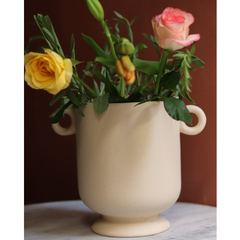 Yellow and pink flowers in an aesthetic white vase