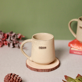 Begin coffee mug on a wooden coaster