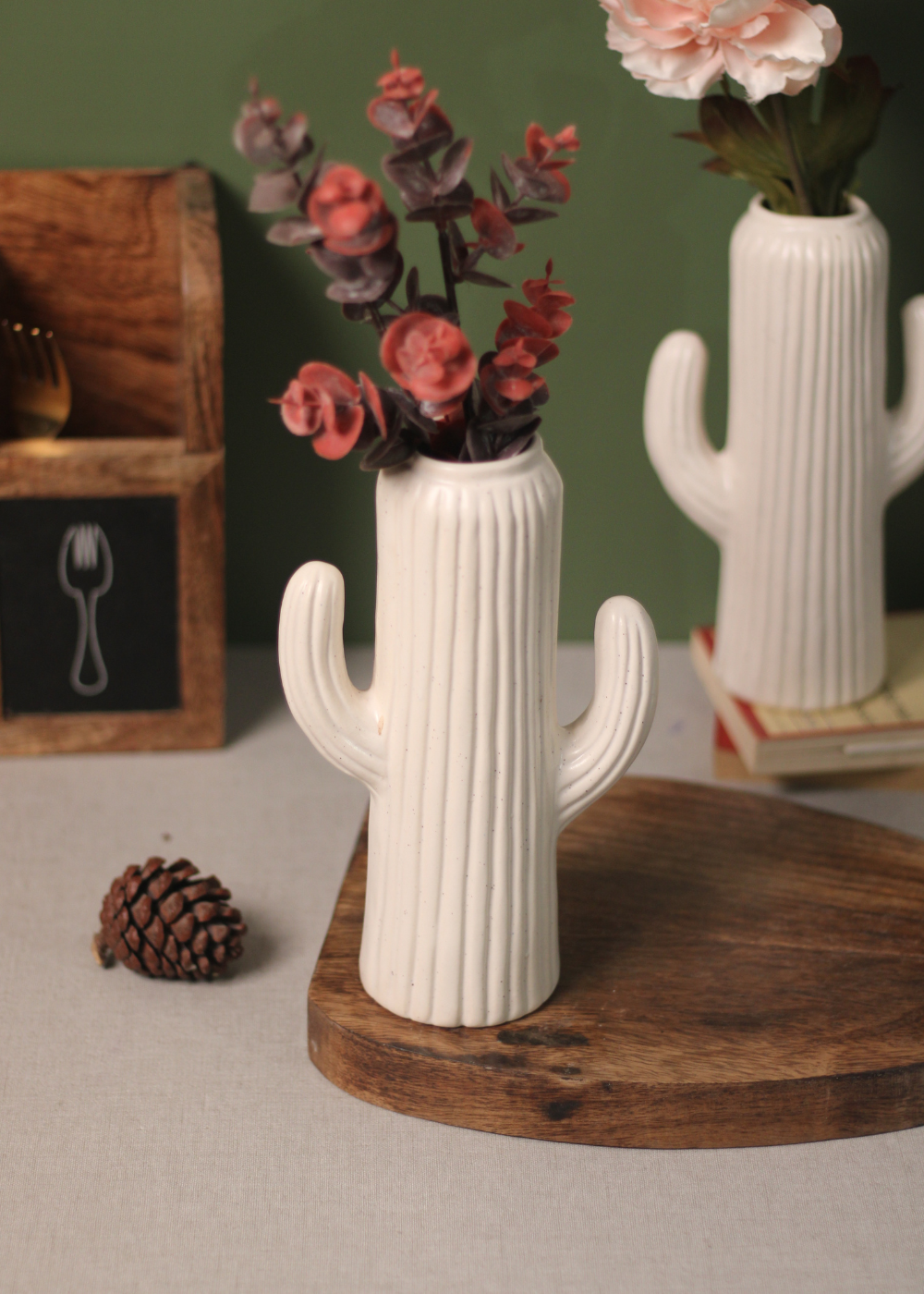 Two white cactus vase with flowers