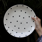 Blue polka dinner plates in hand 