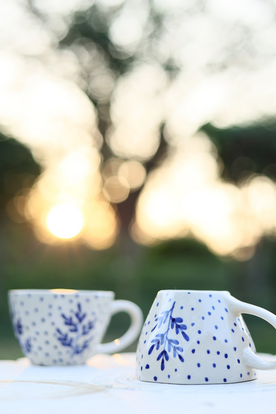 Two blue leaf coffee mug in garden