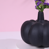 black pumpkin vase with flower