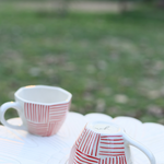 Red all lines coffee mugs in garden 