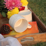 Ceramic coffee mugs in wooden tray 