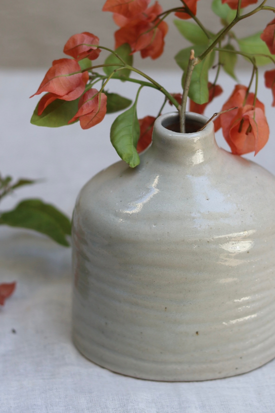Grey handmade vase with flowers 