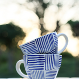 Blue all lines mug in a garden