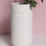 Unique design face vase with red rose