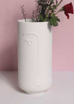 Unique design face vase with red rose