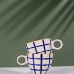 Blue checks coffee mug on each other