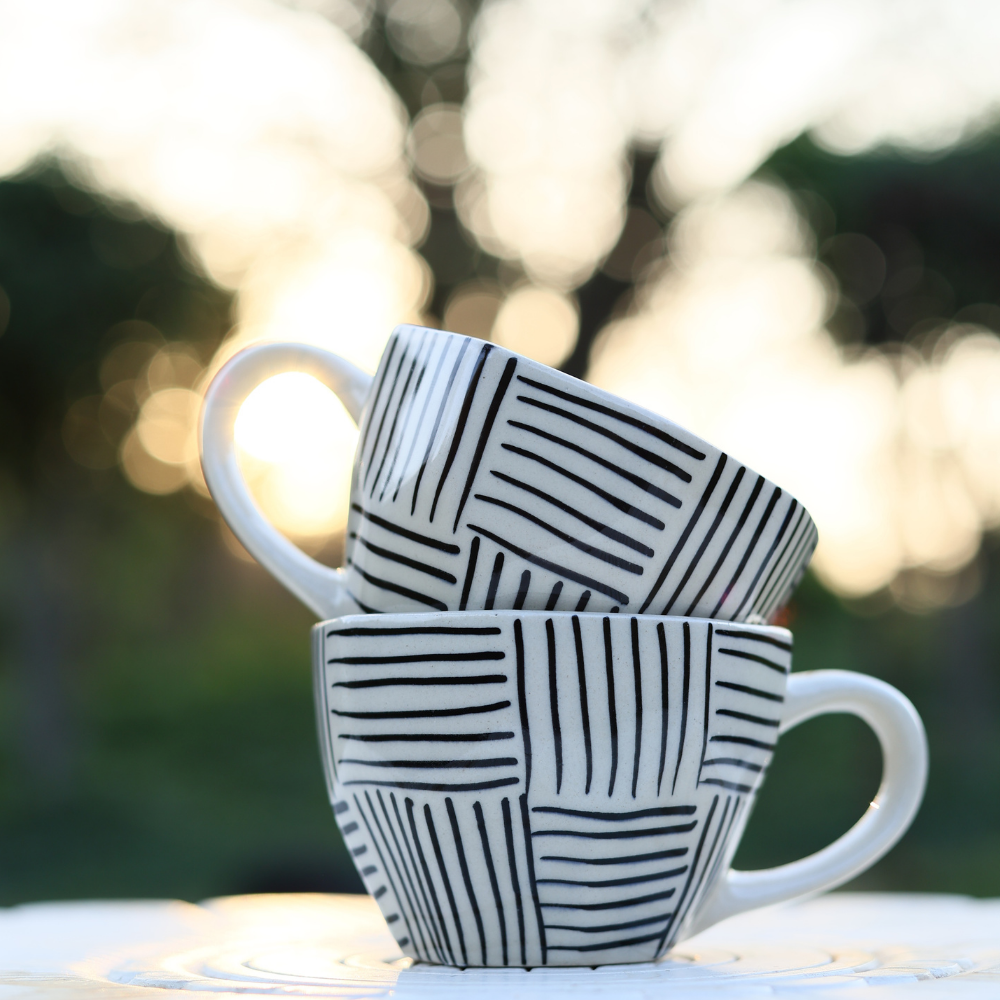 Black and white mugs on each other