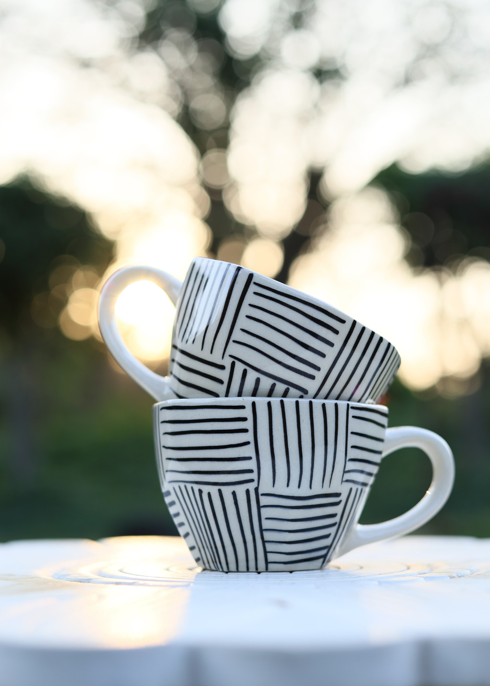 Black and white mugs on each other