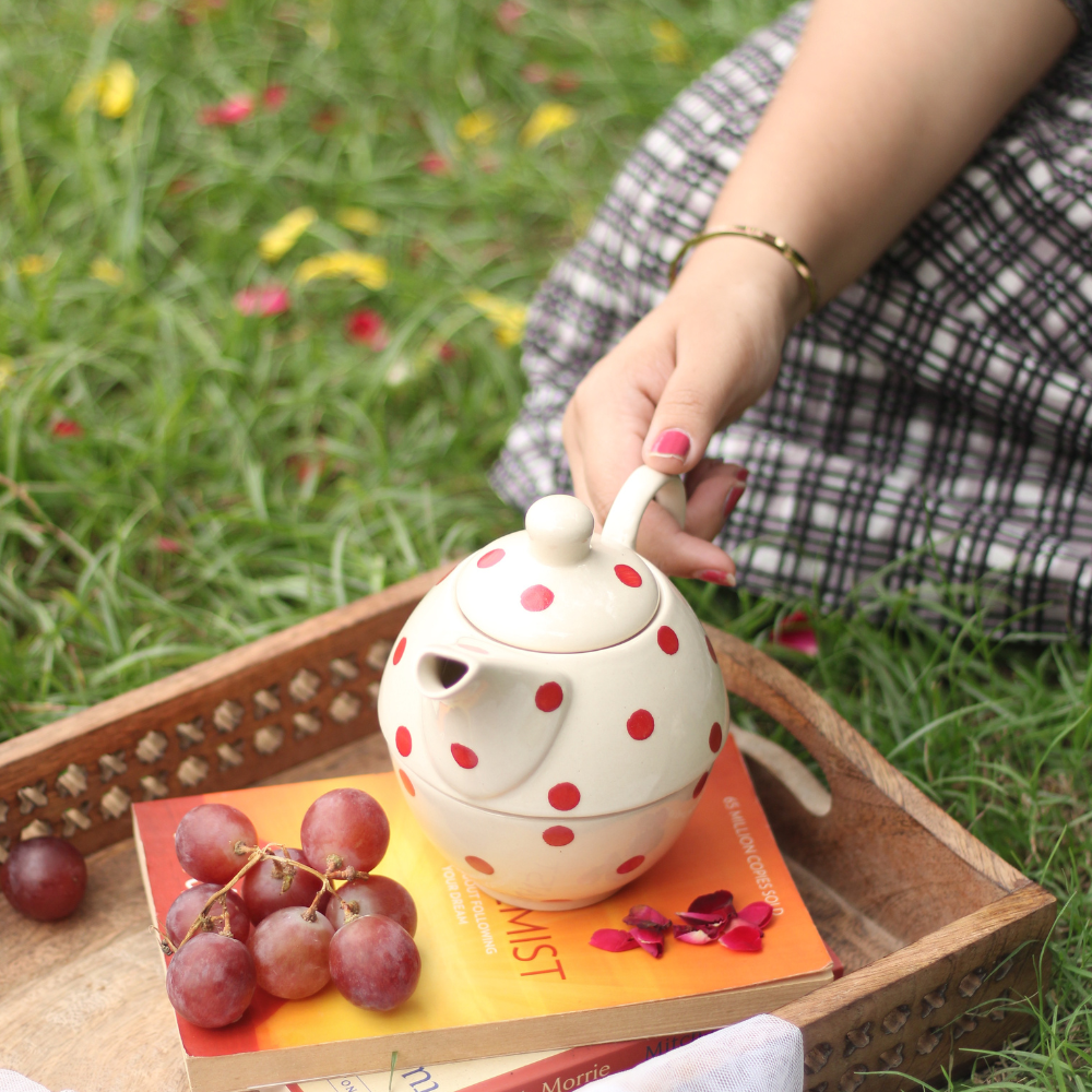 Handmade ceramic tea set in hand 