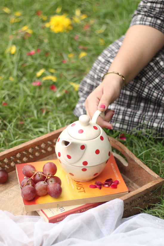 Handmade ceramic tea set in hand 