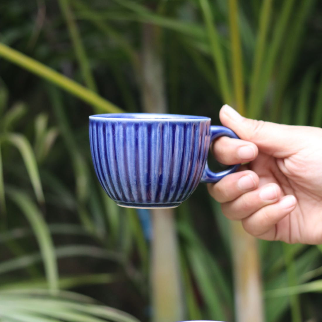 Blue chai cup in hand