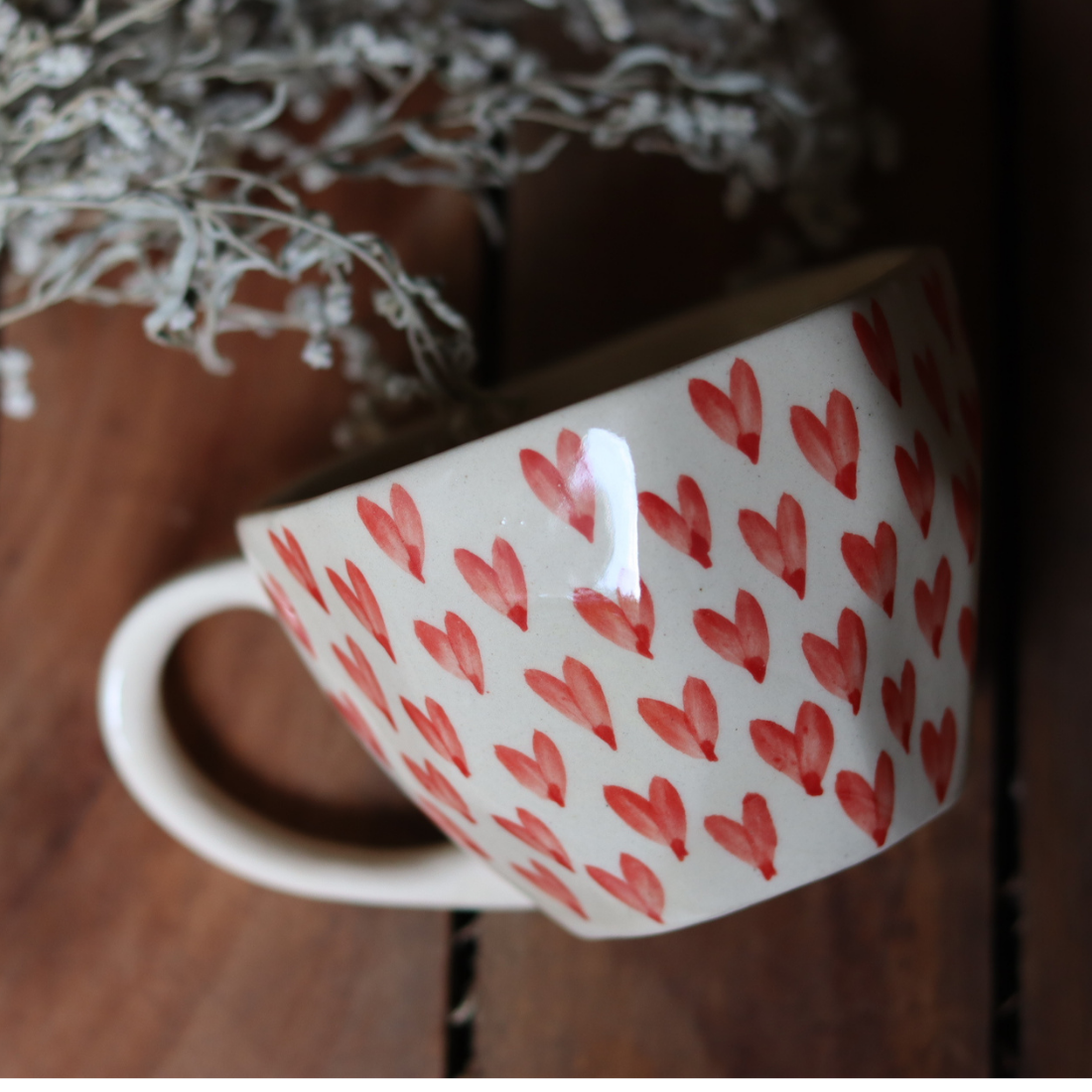 Heart coffee mug on wooden surface
