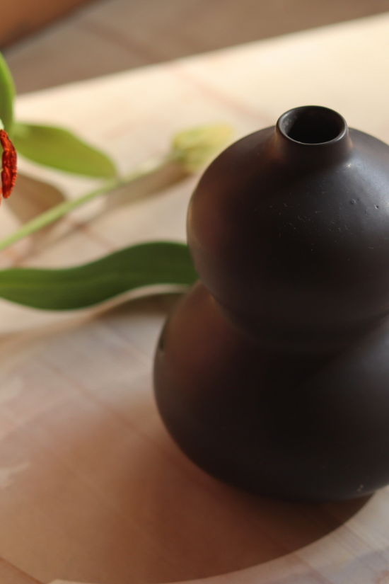 Black moulded vase with flower