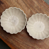 Two handmade ceramic ice cream bowls on wooden surface