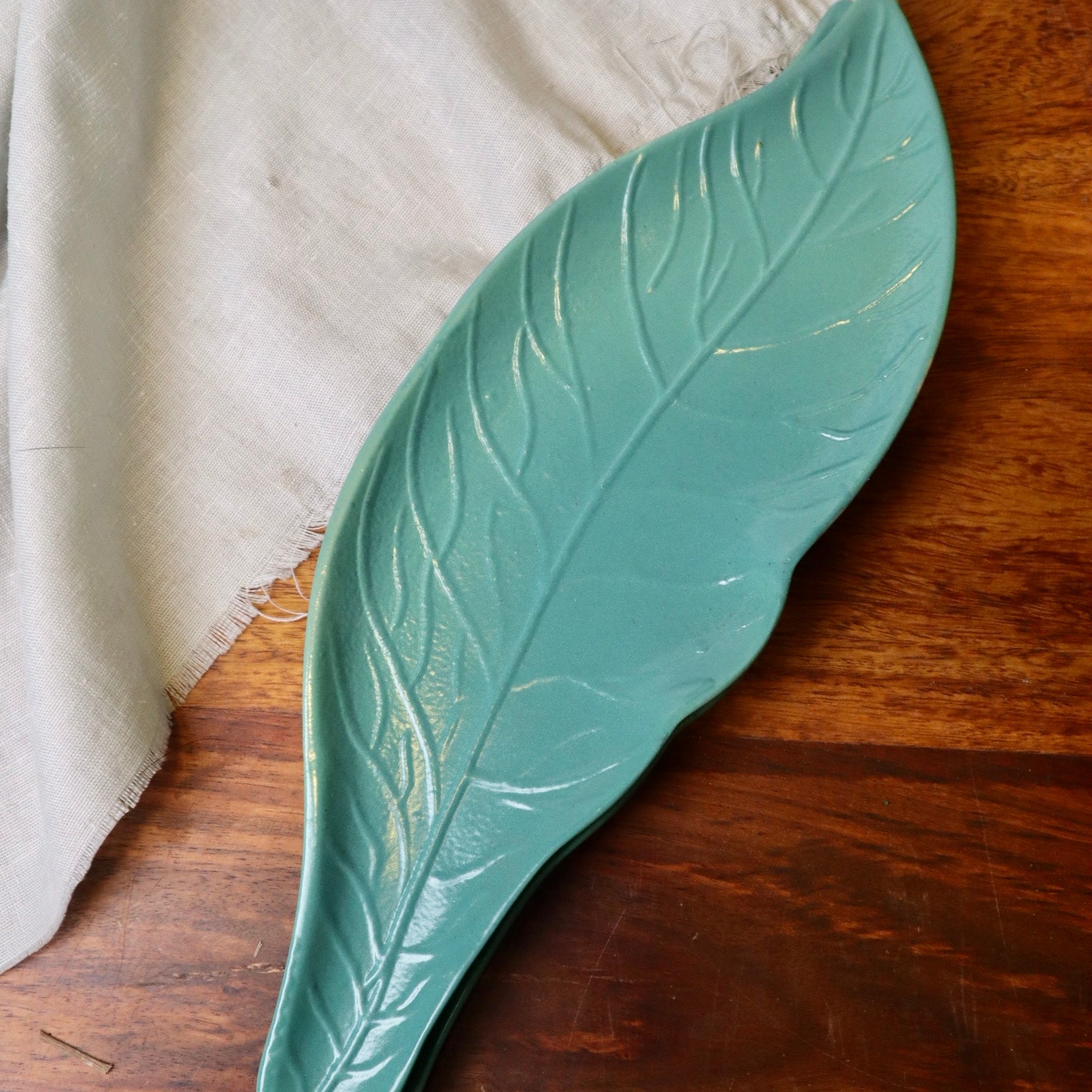 Green leaf shaded platter on wooden surface