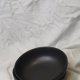 Two black curry bowl on each other
