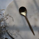 Gold dinner spoon on marble 