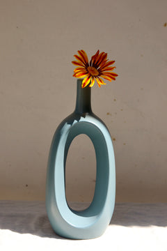 Grey contour vase with yellow flower 