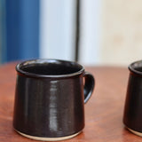 Charcoal coffee mug on a wooden table