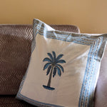 Blue palm cushion on sofa 