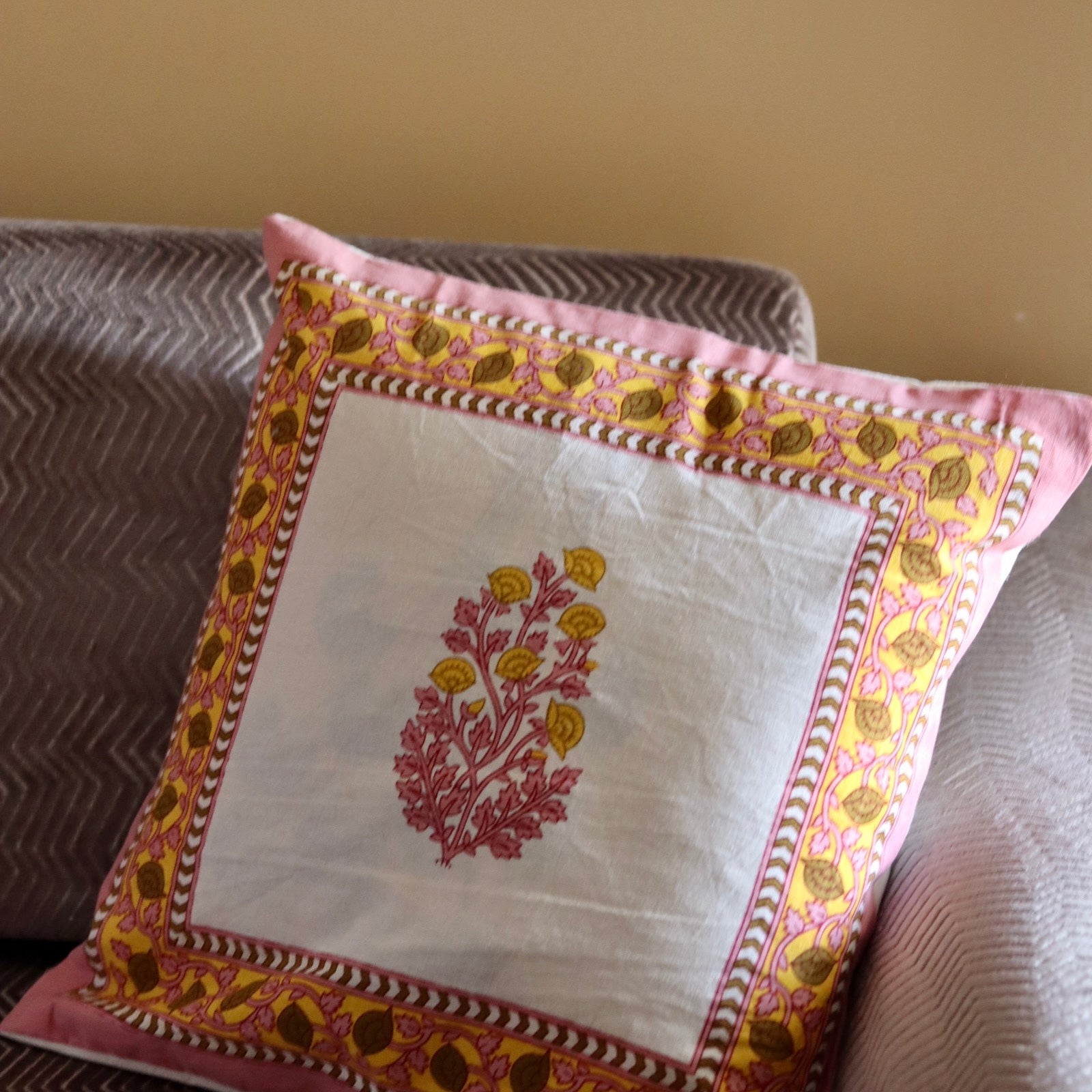 Pink motif cushion cover on sofa
