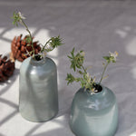 Grey bud vases with flowers