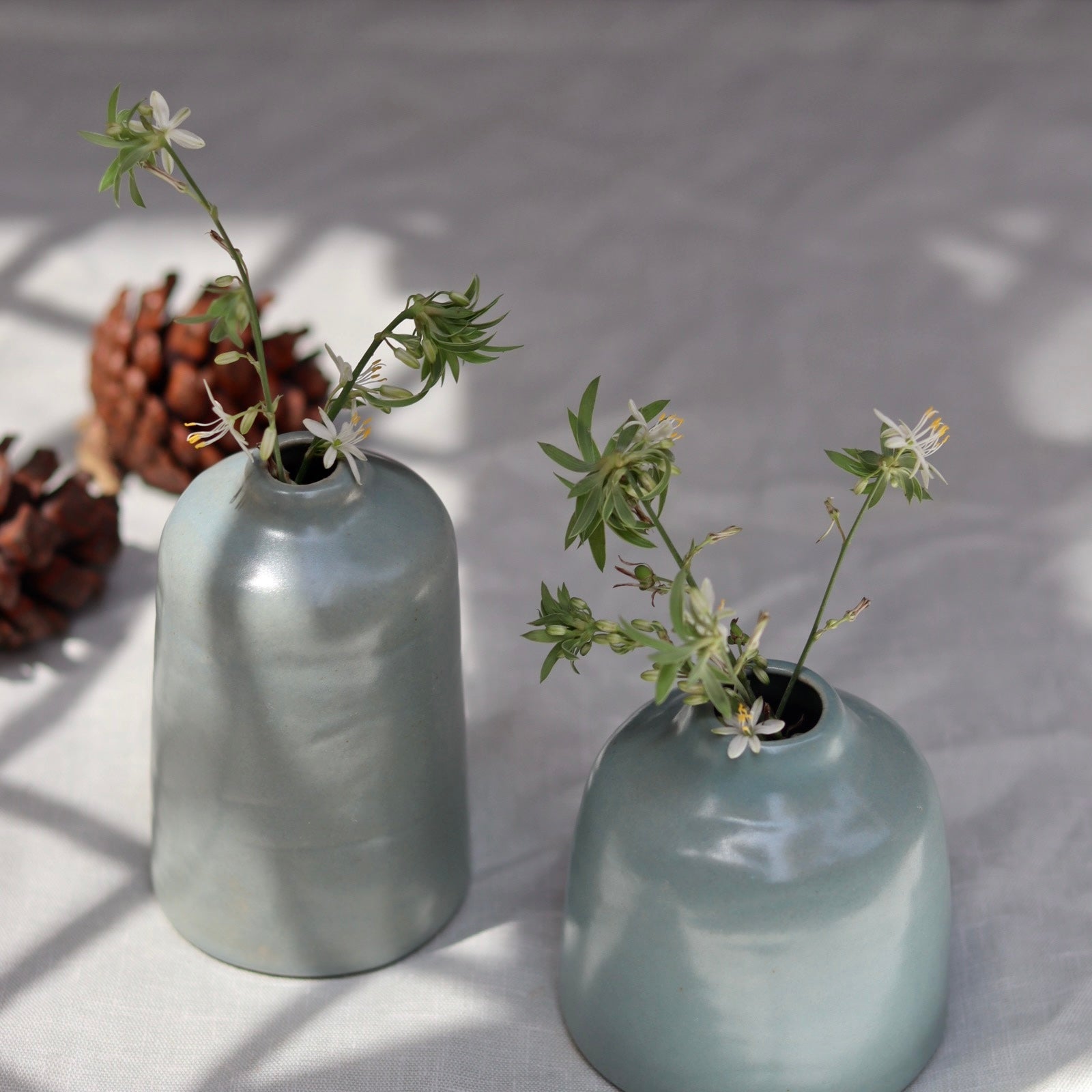 Grey bud vases with flowers