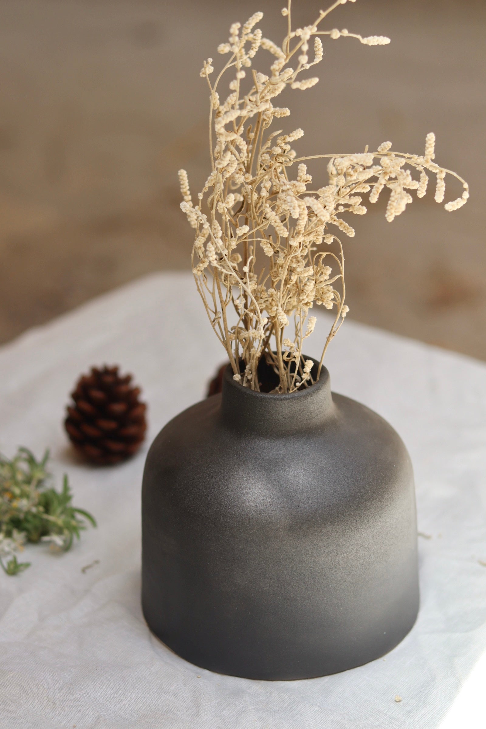 Black round vase with flower