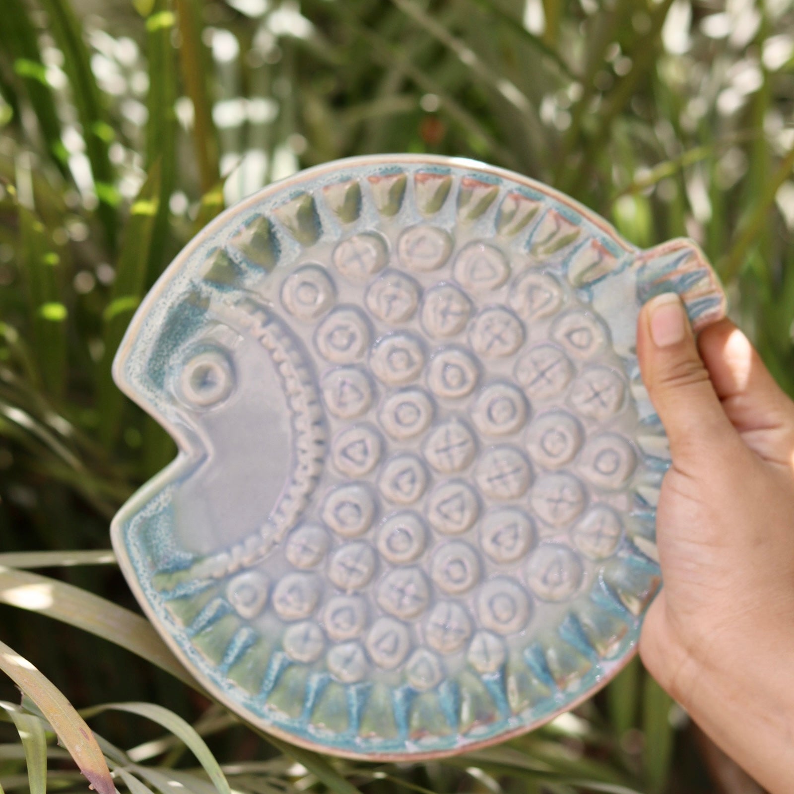 Ceramic fish platter in hand