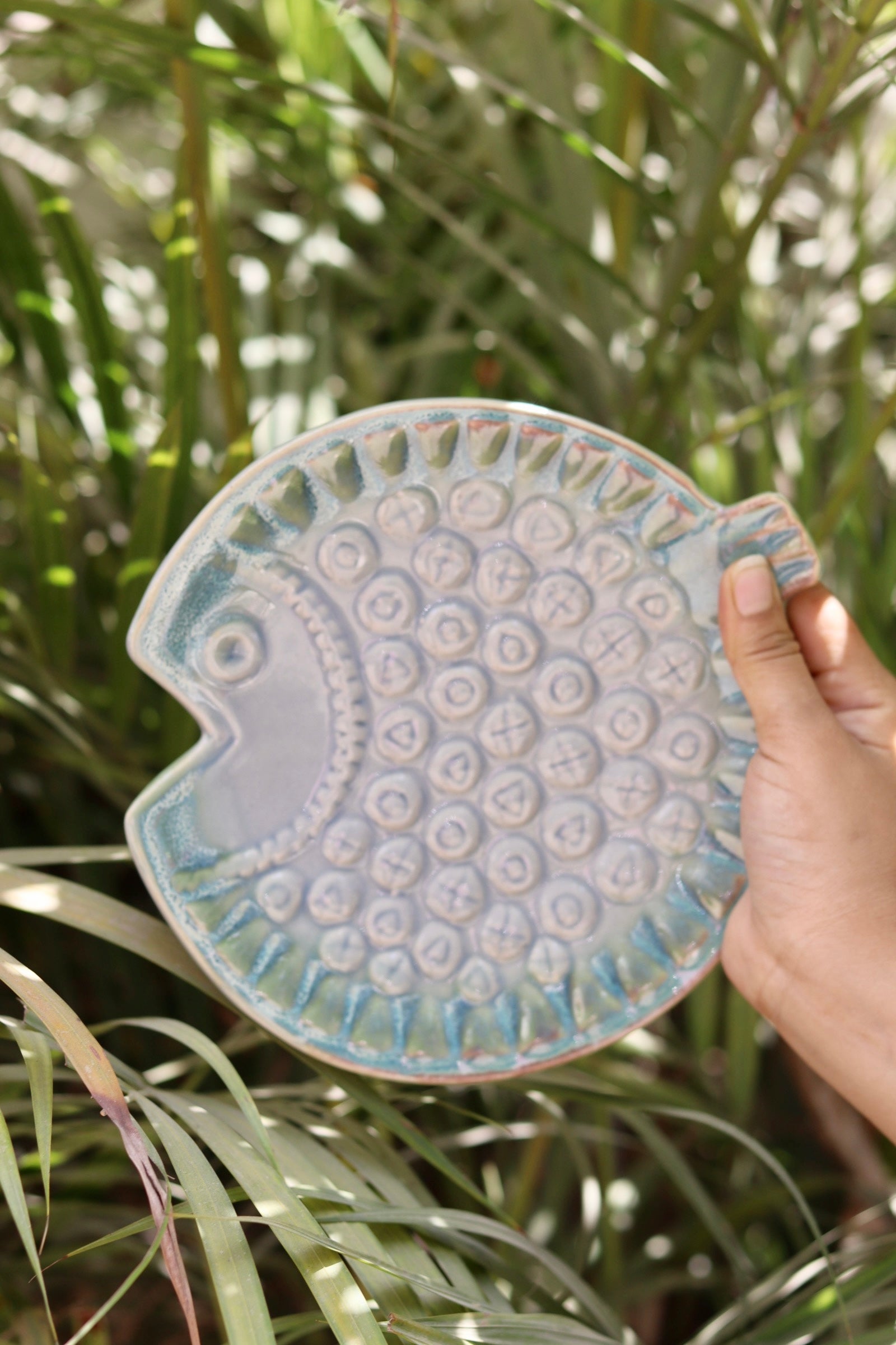 Ceramic fish platter in hand