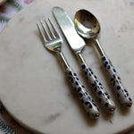 Handmade ceramic cutlery set on marble 