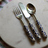 Handmade ceramic cutlery set on marble 