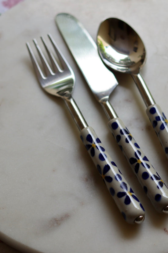 Handmade ceramic cutlery set on marble 