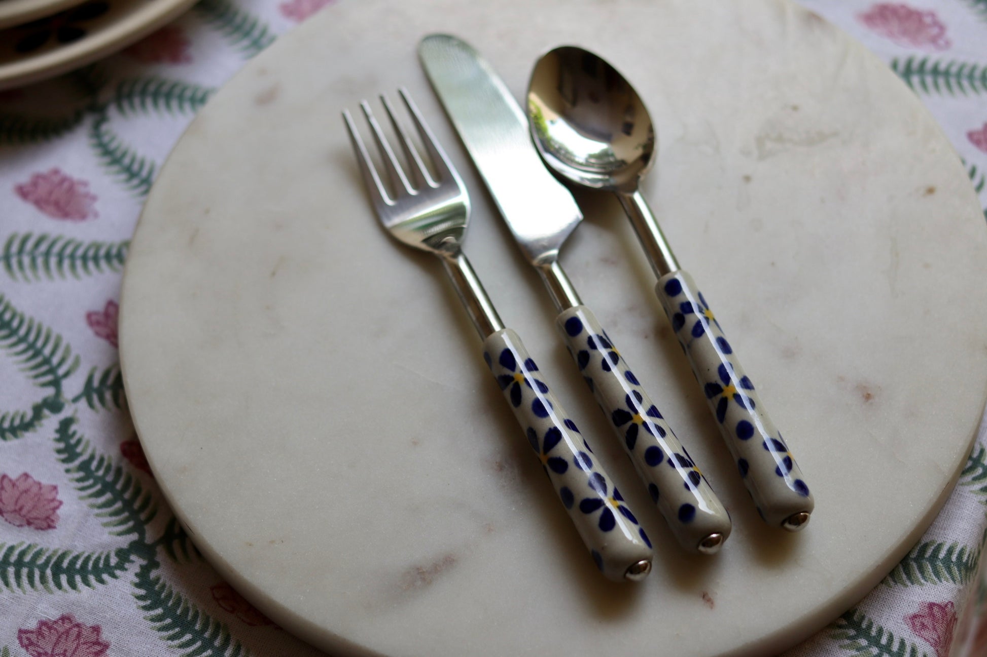 Handmade ceramic cutlery set on marble 
