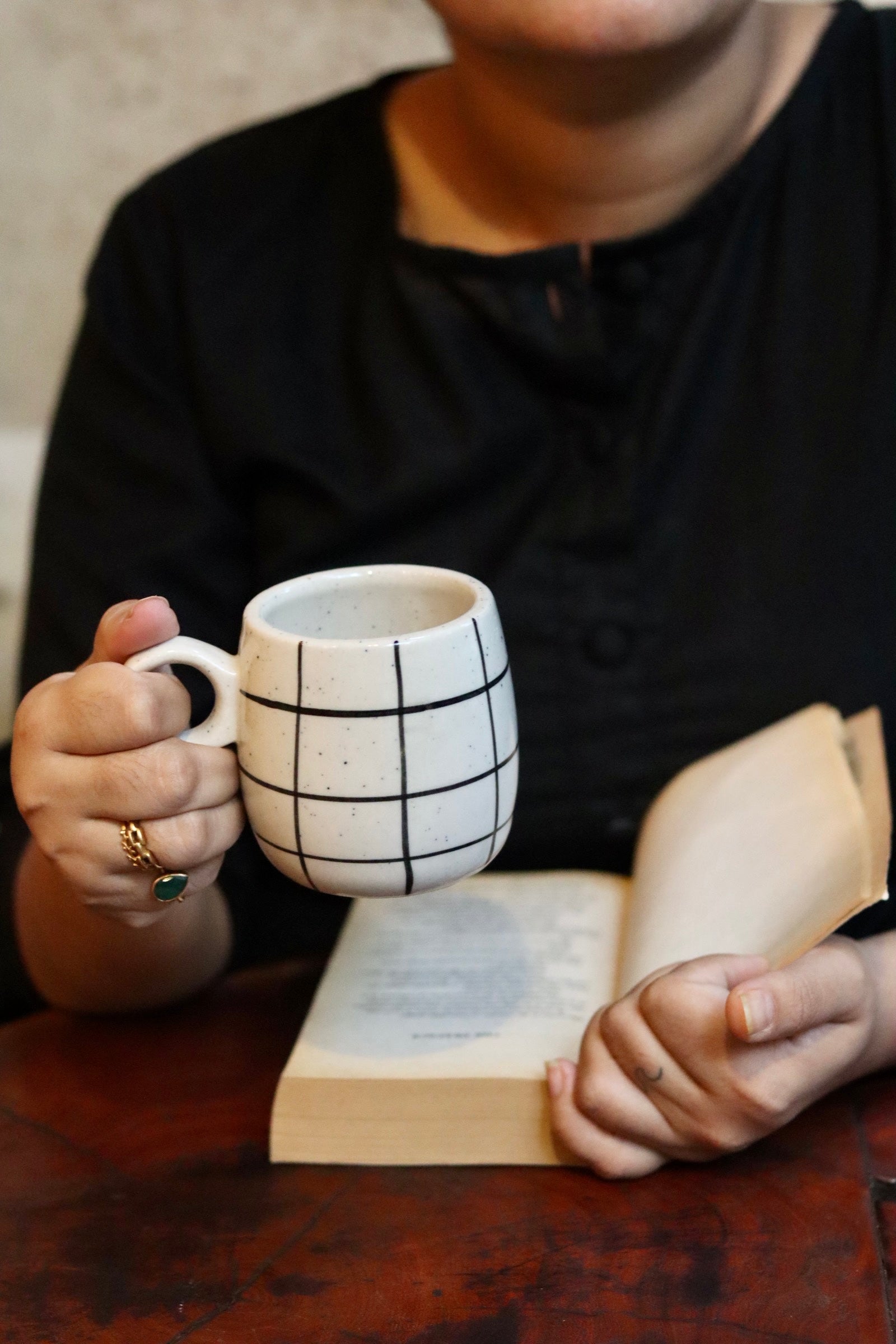 Someone is drinking tea and reading book