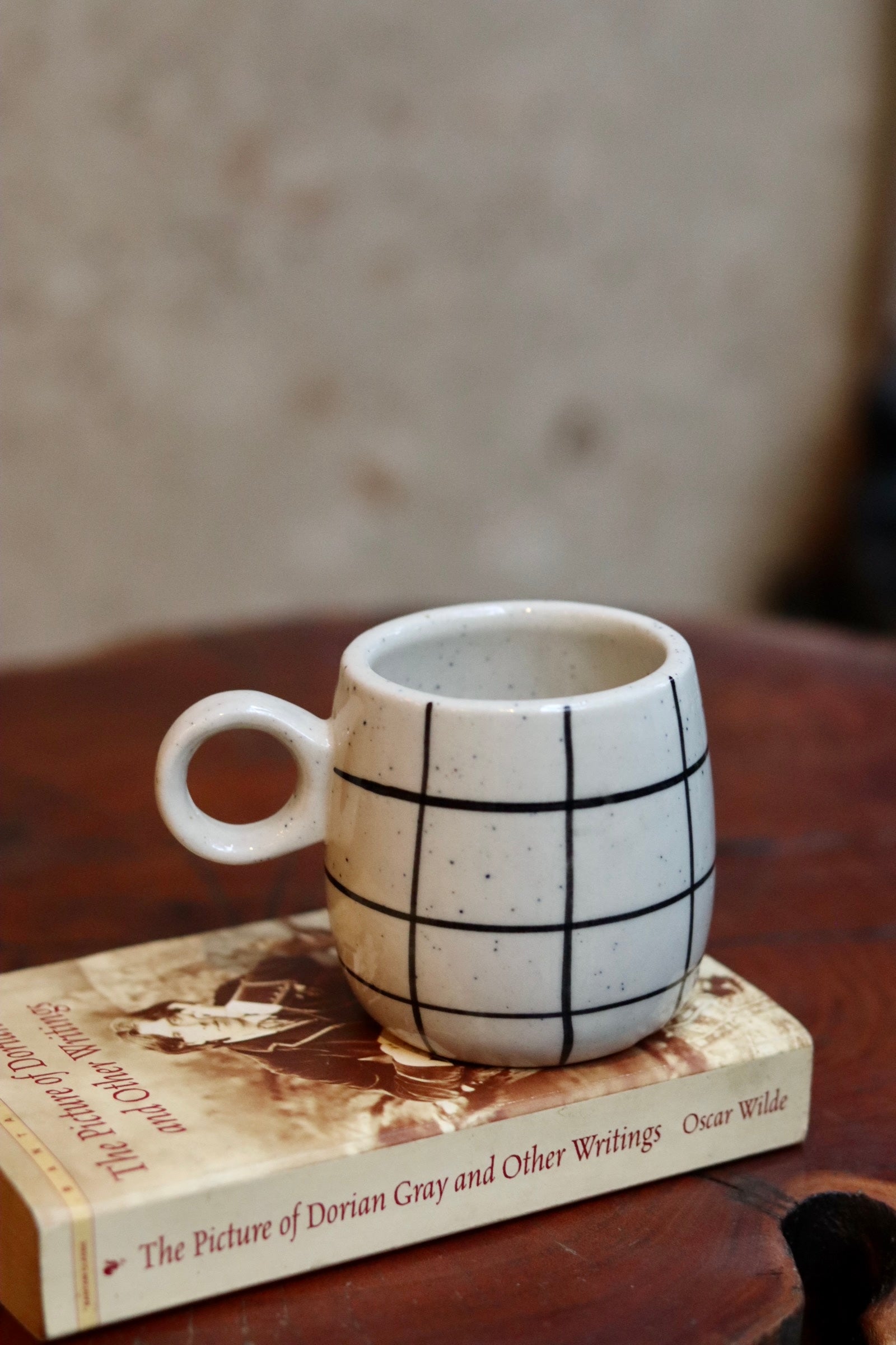 Black checkered coffee mug on a book