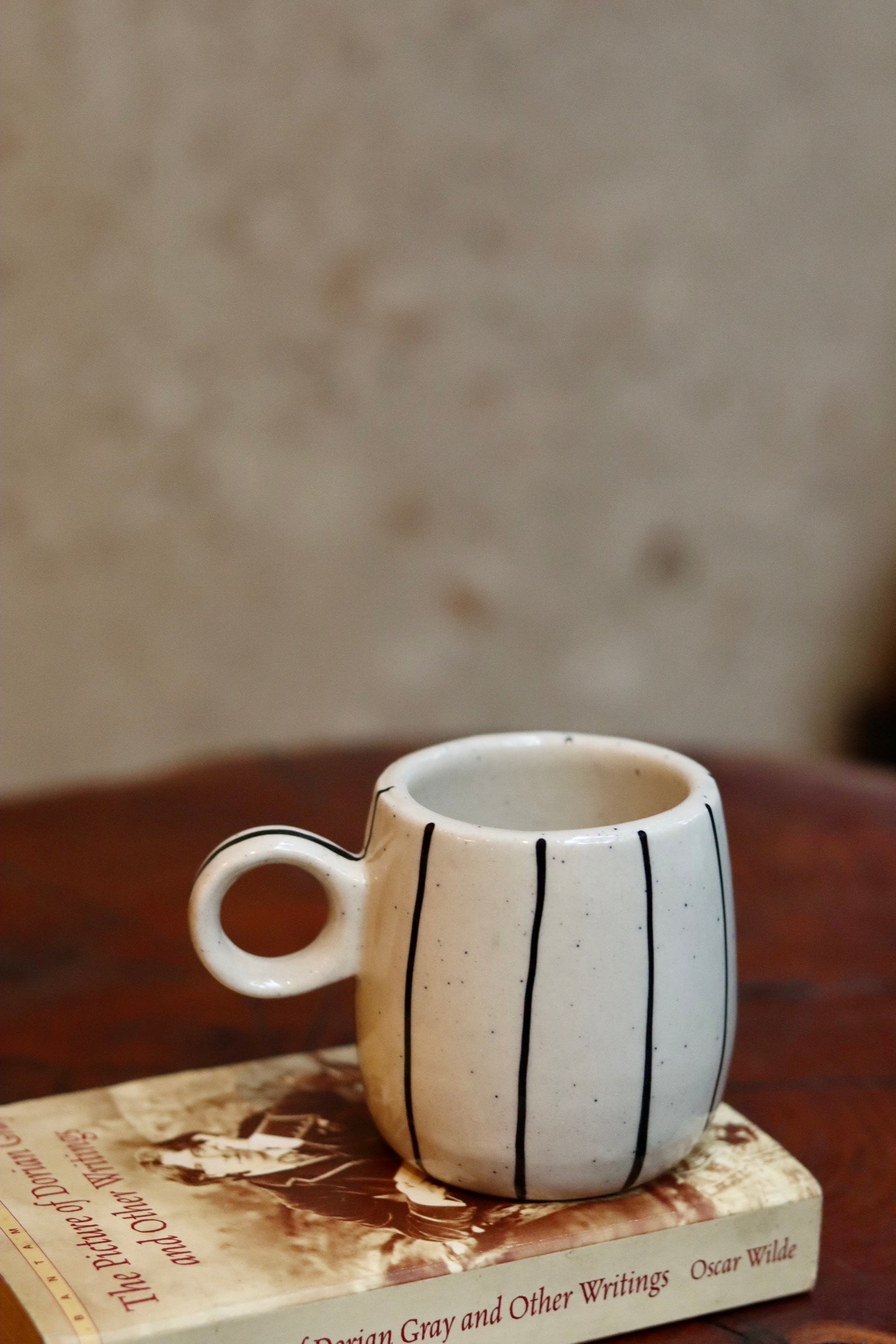 Black lined cuddle mug on a book