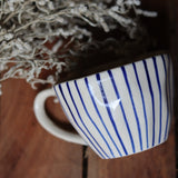 Blue lined mug on wooden surface