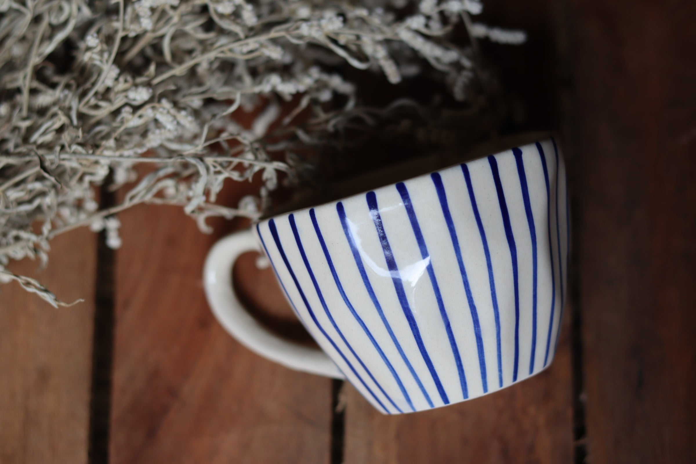 Blue lined mug on wooden surface