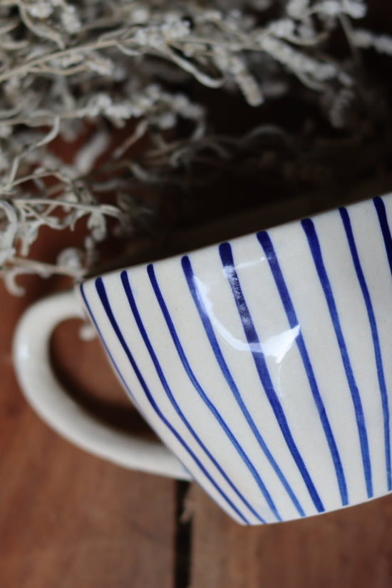 Blue lined mug on wooden surface