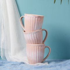 Three pink vintage coffee mug laying on each other